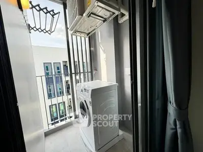 Modern balcony with washing machine and city view, perfect for urban living convenience.