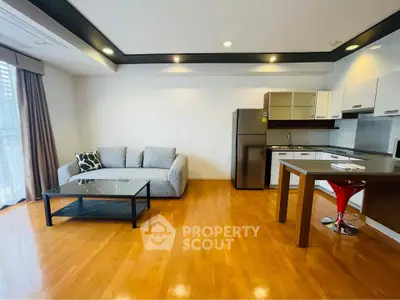 Modern open-plan living room with sleek kitchen and stylish furnishings.