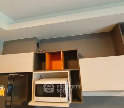 Modern kitchen with microwave and sleek cabinetry design