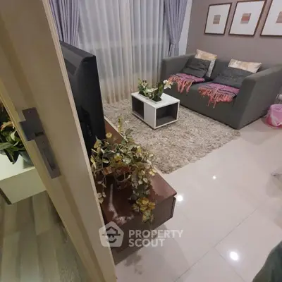 Cozy living room with modern decor and plush seating in a stylish apartment.