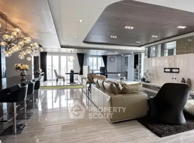 Luxurious open-plan living room with modern decor and elegant lighting