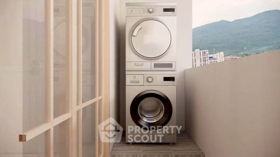 Modern balcony with stacked washer and dryer offering mountain views.