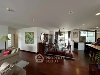 Spacious open-plan living and dining area with modern decor and natural light.
