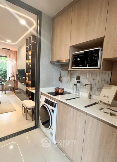 Modern kitchen with sleek appliances and open layout in stylish apartment