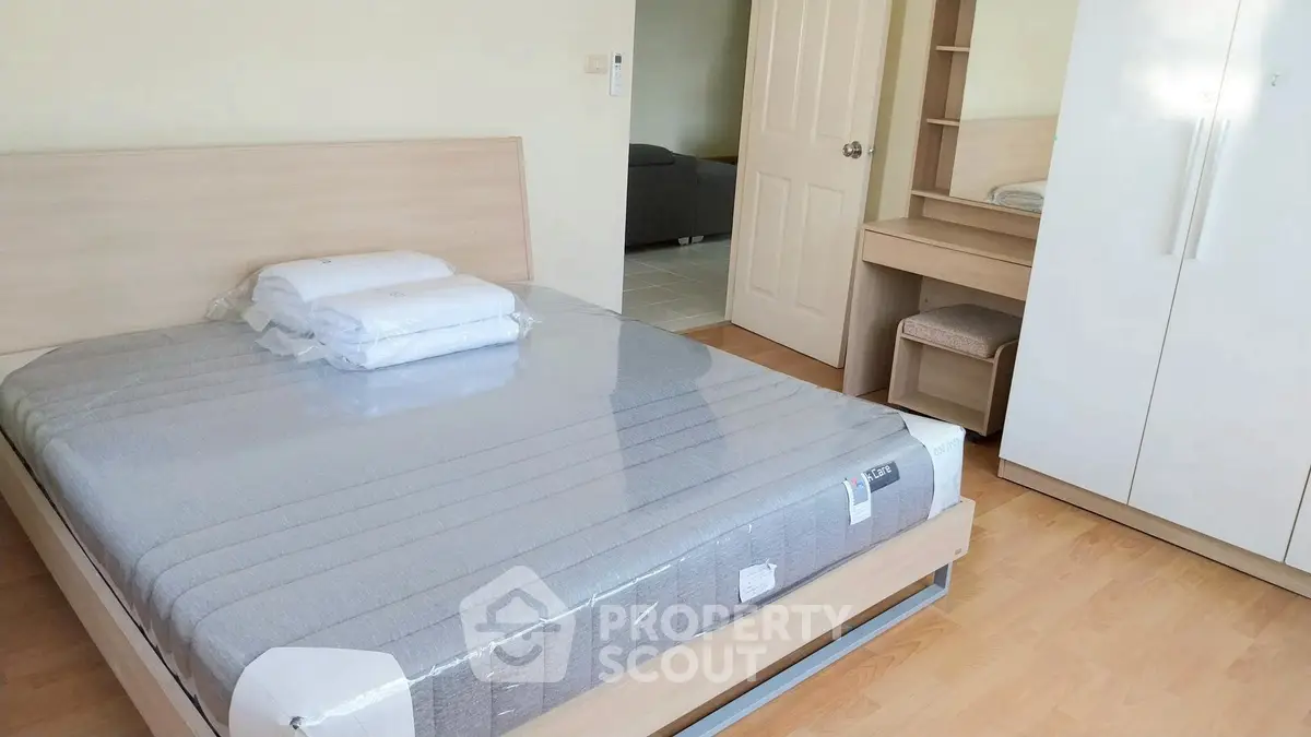 Modern bedroom with new mattress and stylish furniture in a bright apartment.