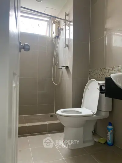 Modern bathroom with shower and toilet in sleek design