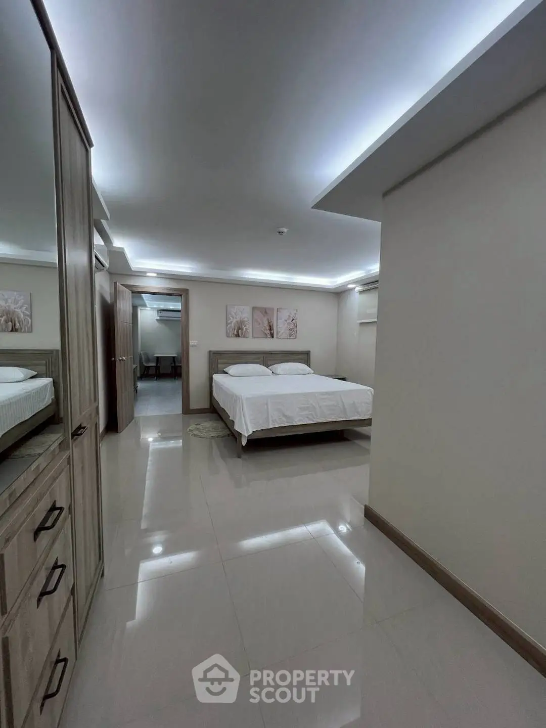 Spacious modern bedroom with elegant decor and ambient lighting