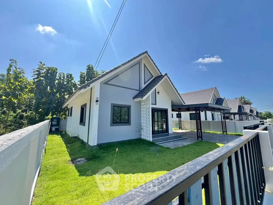 Charming modern house with lush green lawn and clear blue sky, perfect for family living.