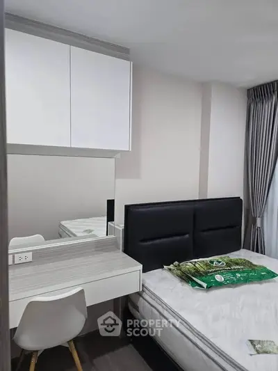 Modern bedroom with sleek design, featuring a comfortable bed, stylish desk, and ample storage space.