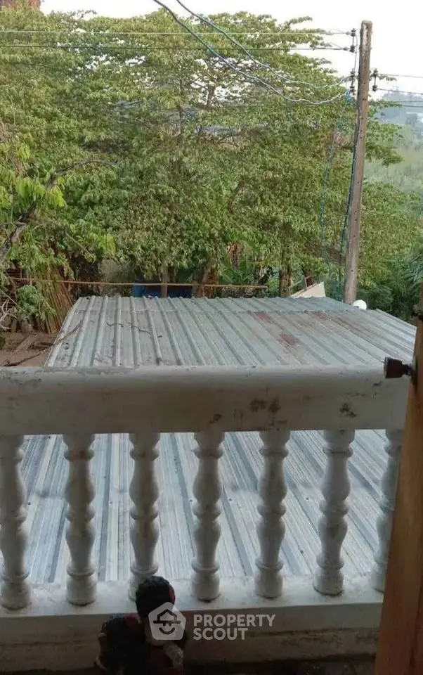 Charming balcony view with lush greenery and serene surroundings