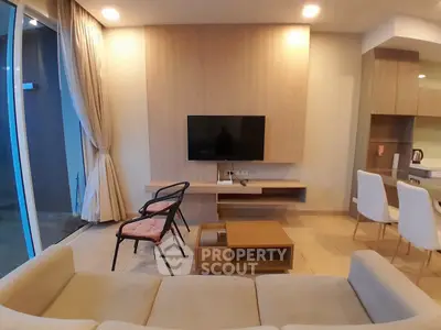 Modern living room with stylish furniture and wall-mounted TV, perfect for relaxation and entertainment.