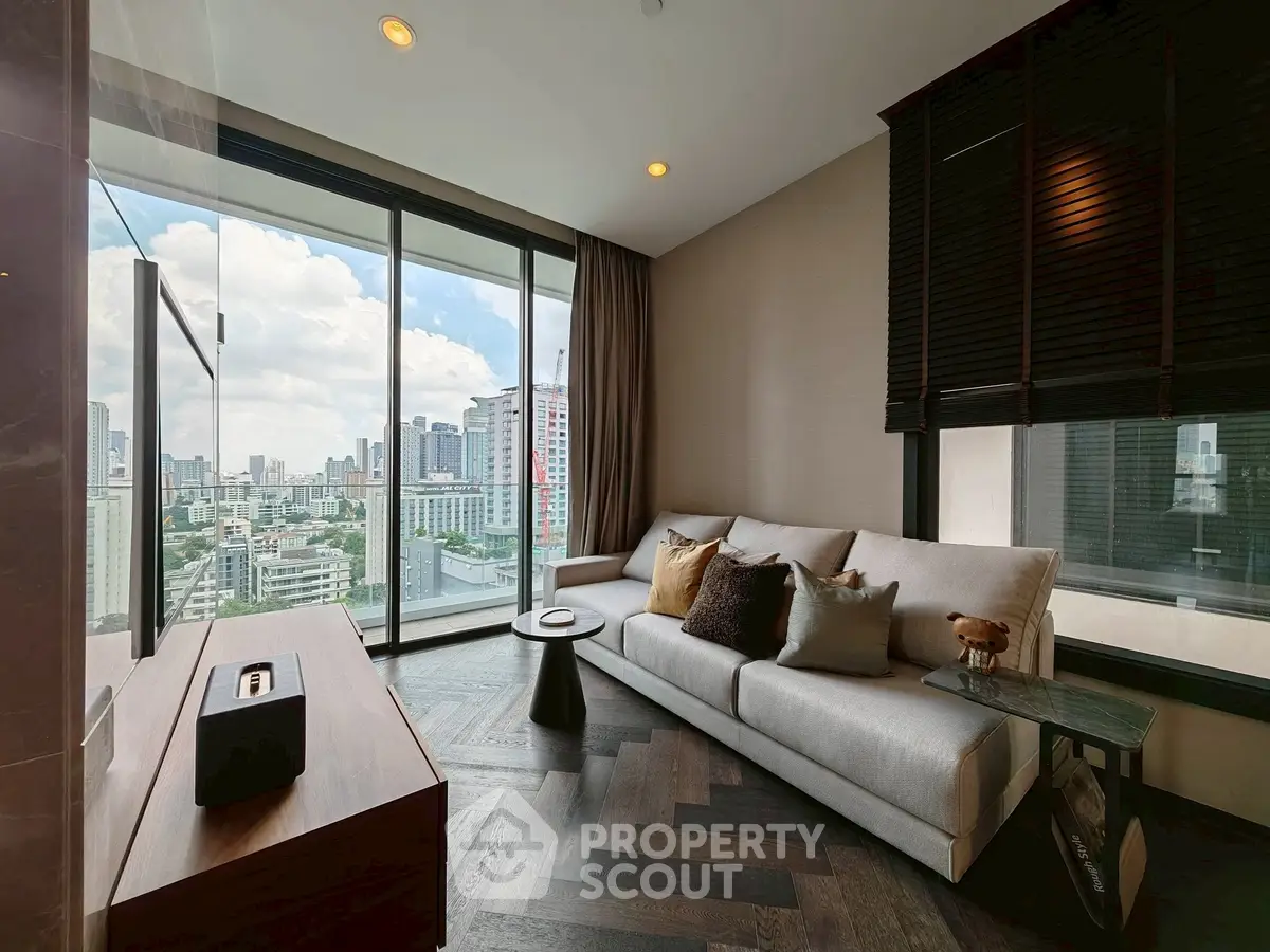 Modern living room with large windows offering stunning city views and elegant decor.