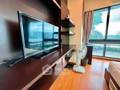 Modern living room with large window and sleek entertainment unit
