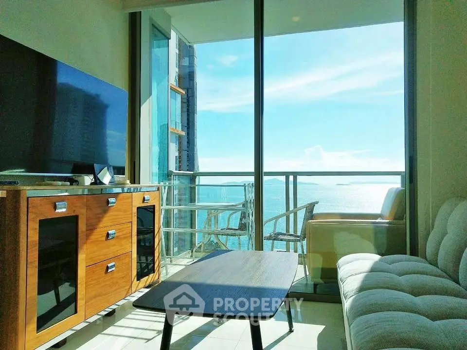 Stunning living room with ocean view and modern furnishings in a high-rise apartment.