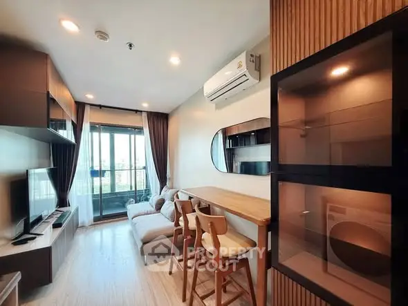 Modern living room with stylish furniture and balcony view