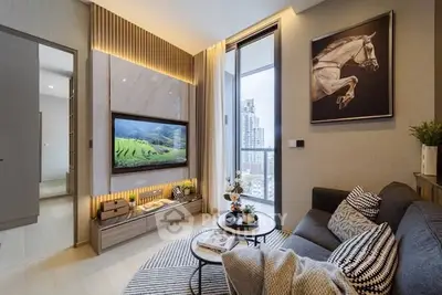 Modern living room with city view, stylish decor, and cozy seating area.