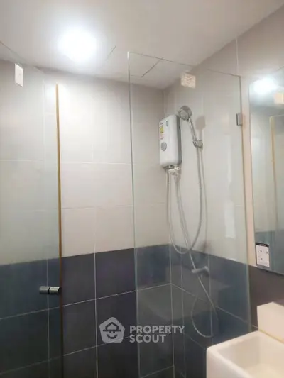 Modern bathroom with glass shower enclosure and sleek tile design