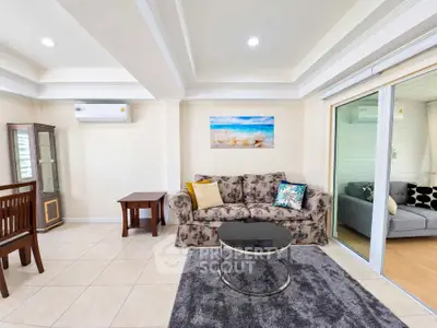 Spacious living room with elegant decor and cozy seating area, perfect for relaxation and entertainment.