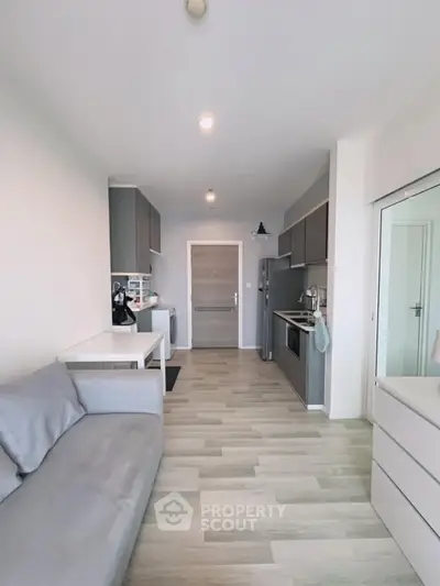 Modern open-plan kitchen and living area with sleek design and neutral tones.