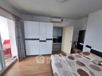 Spacious bedroom with modern furniture and balcony access