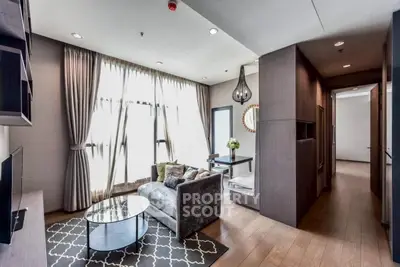 Modern living room with elegant decor and large windows in a stylish apartment.