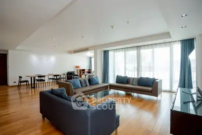 Spacious modern living room with hardwood floors and large windows