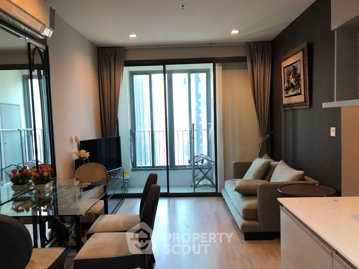 Modern living room with elegant decor and large windows offering city views.