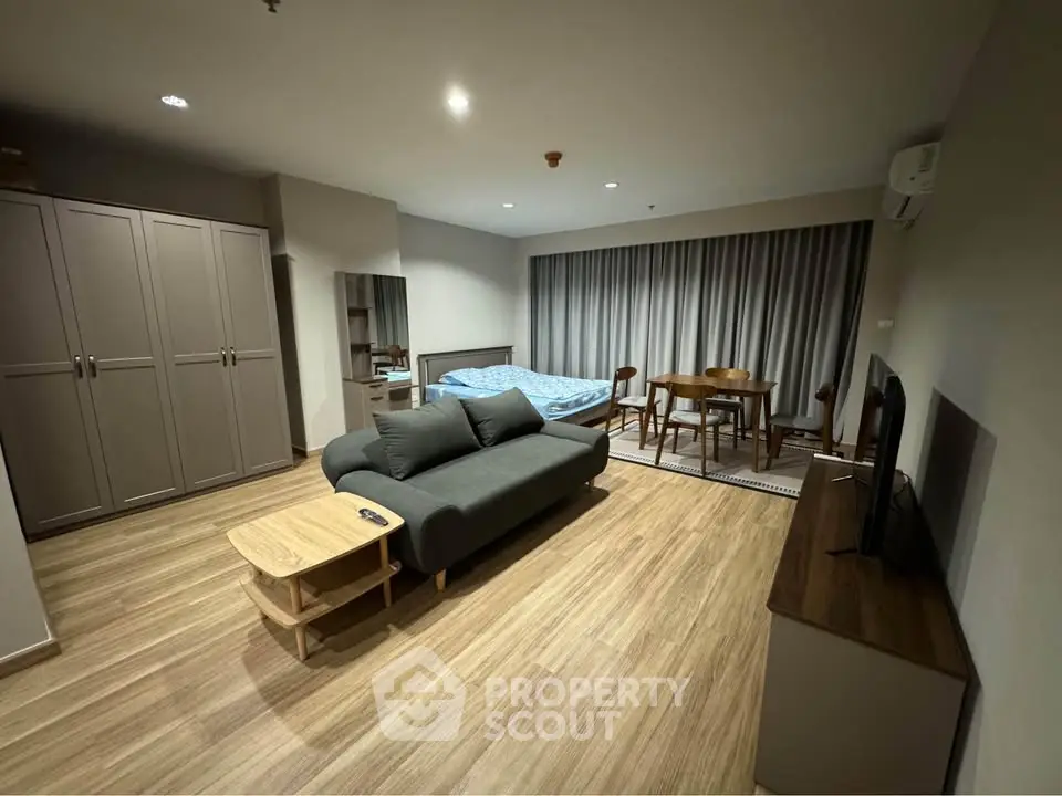 Spacious studio apartment with modern furnishings and wooden flooring