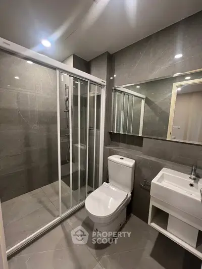 Modern bathroom with sleek shower and elegant fixtures in contemporary apartment