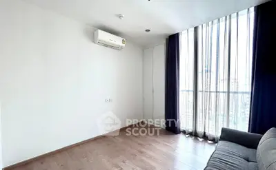 Bright minimalist living room with large window and city view