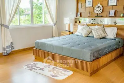 Spacious bedroom with elegant decor and large window view