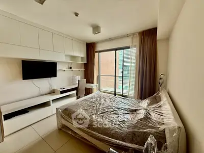 Modern bedroom with balcony access and sleek furniture in urban apartment