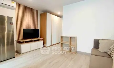 Modern living room with sleek design, featuring a TV, storage, and stylish wooden accents.