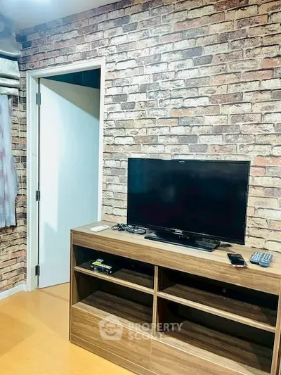 Modern living room with brick accent wall and sleek TV stand