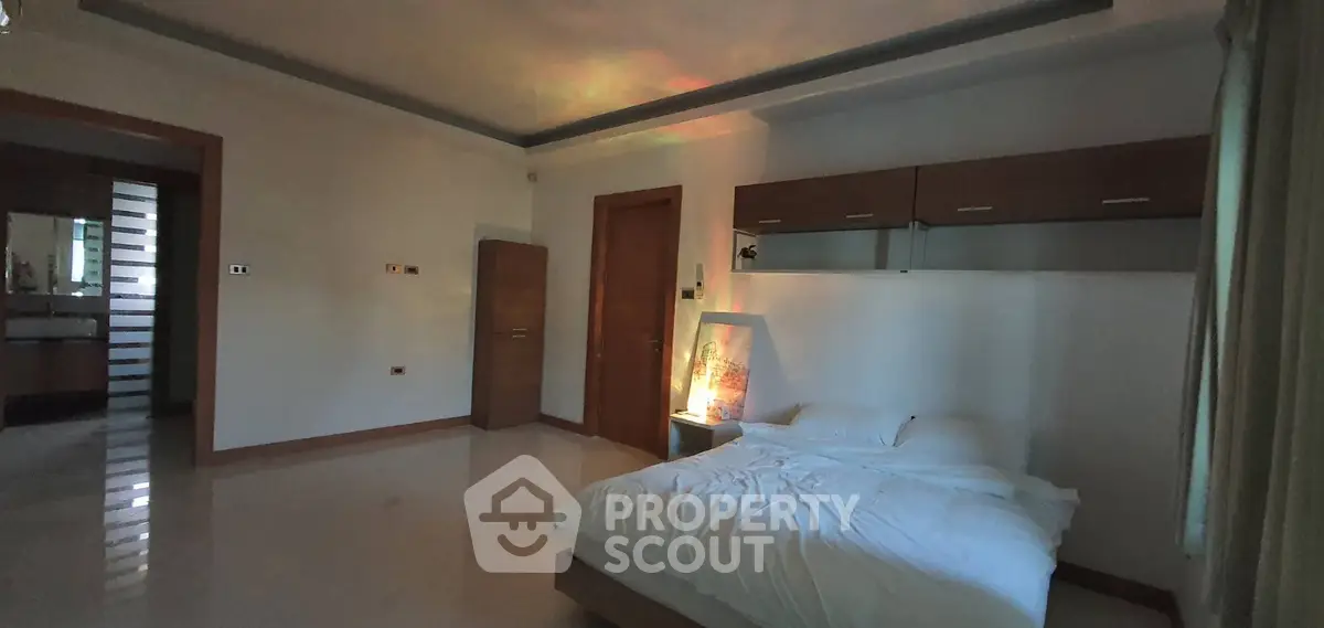 Spacious bedroom with modern design and ambient lighting
