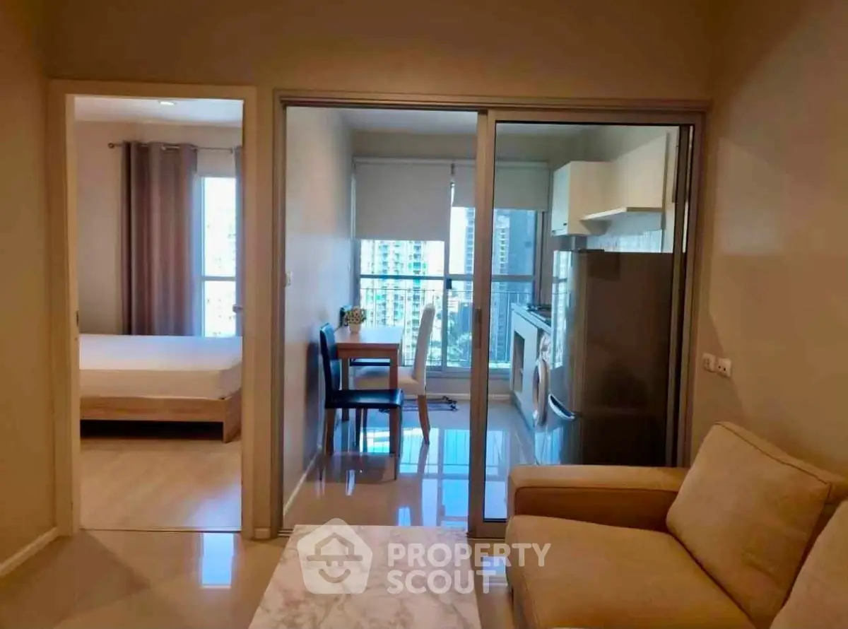 Modern apartment interior with cozy living room, dining area, and bedroom view.