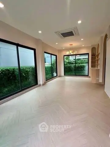 Spacious modern living room with large windows and garden view