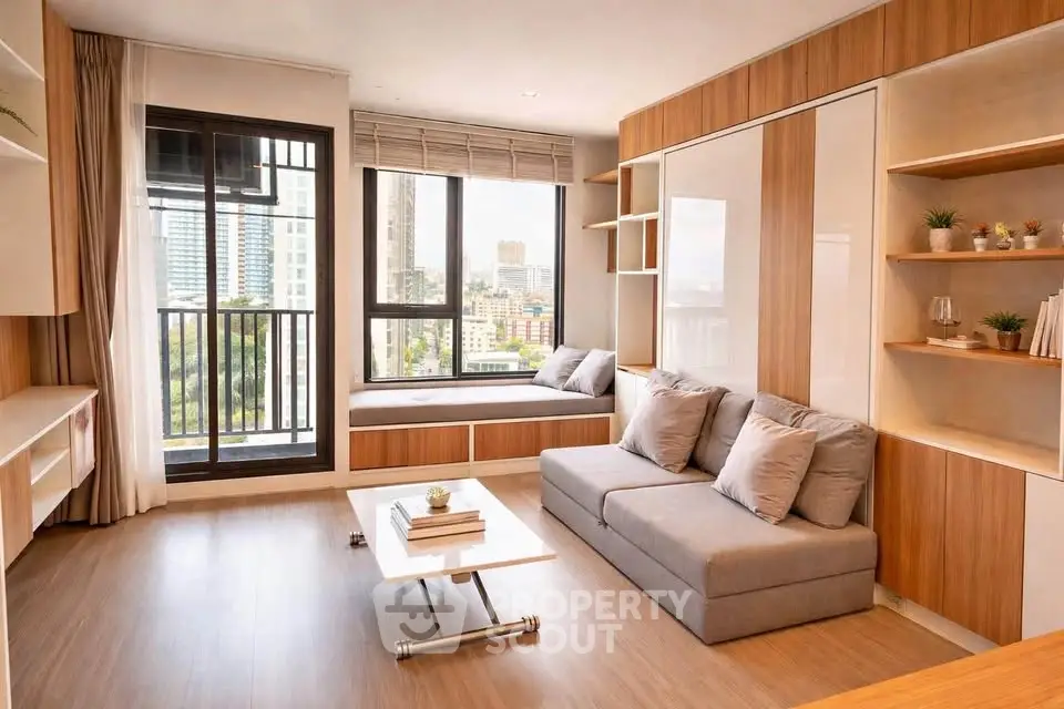 Modern living room with city view, featuring cozy seating and stylish decor.