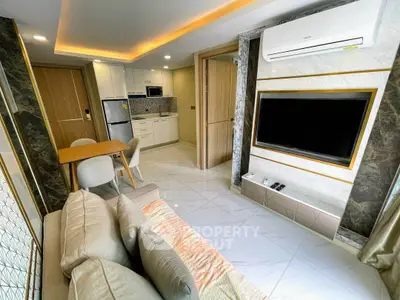 Modern living room with open kitchen, stylish decor, and air conditioning