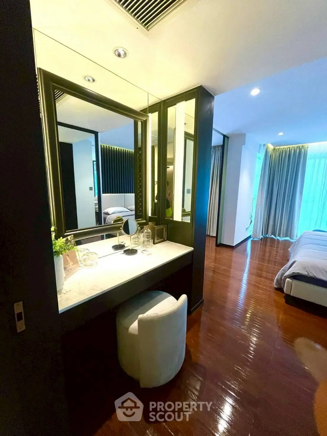 Luxurious bedroom with elegant vanity and floor-to-ceiling windows