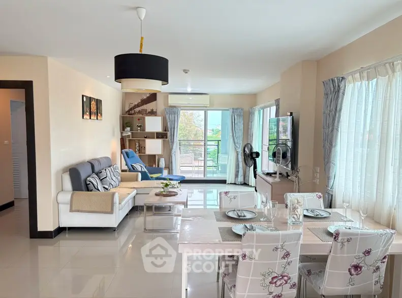 Spacious living room with modern decor and large windows offering natural light.