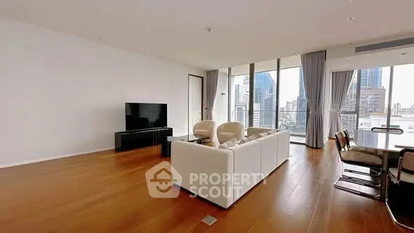 Spacious modern living room with city view and elegant furnishings.