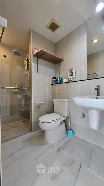 Modern bathroom with sleek fixtures and spacious shower area