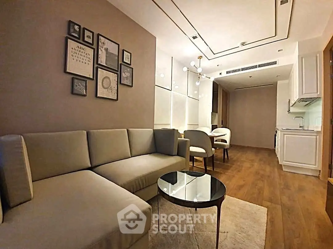 Modern living room with cozy sectional sofa and elegant dining area in open layout apartment.