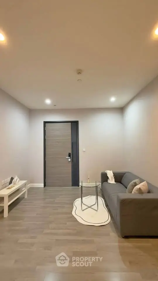 Modern minimalist living room with sleek gray sofa and stylish decor