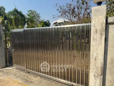 Modern stainless steel gate with sleek design in residential area