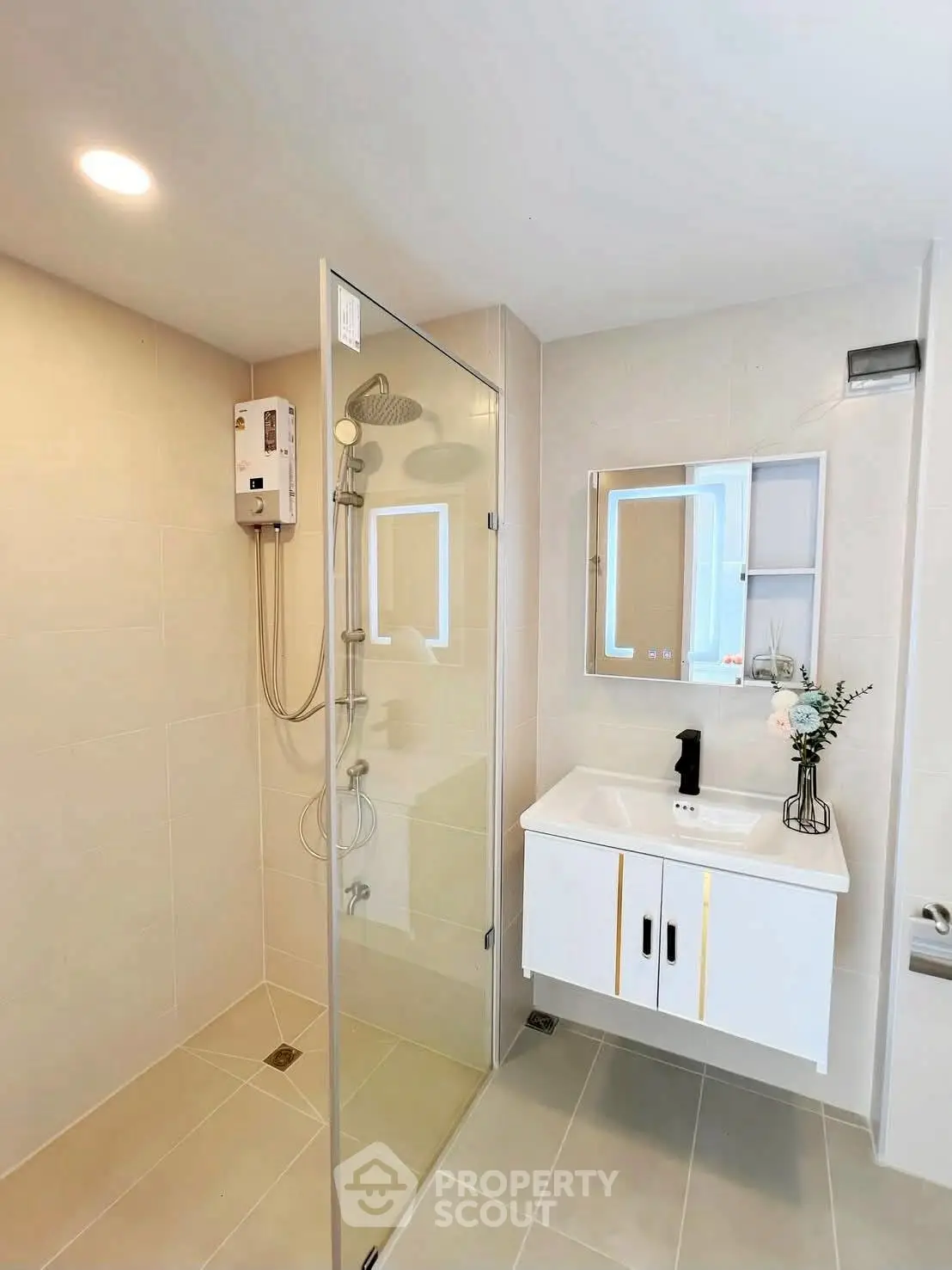 Modern bathroom with glass shower and sleek vanity in a contemporary home.