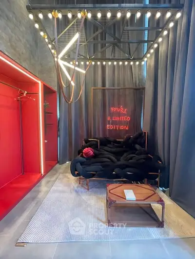 Modern living room with unique lighting and bold red accents