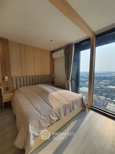 Spacious bedroom with panoramic city views through floor-to-ceiling windows, modern wooden wall paneling, and elegant interior design.