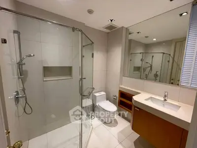 Modern bathroom with glass shower and sleek fixtures